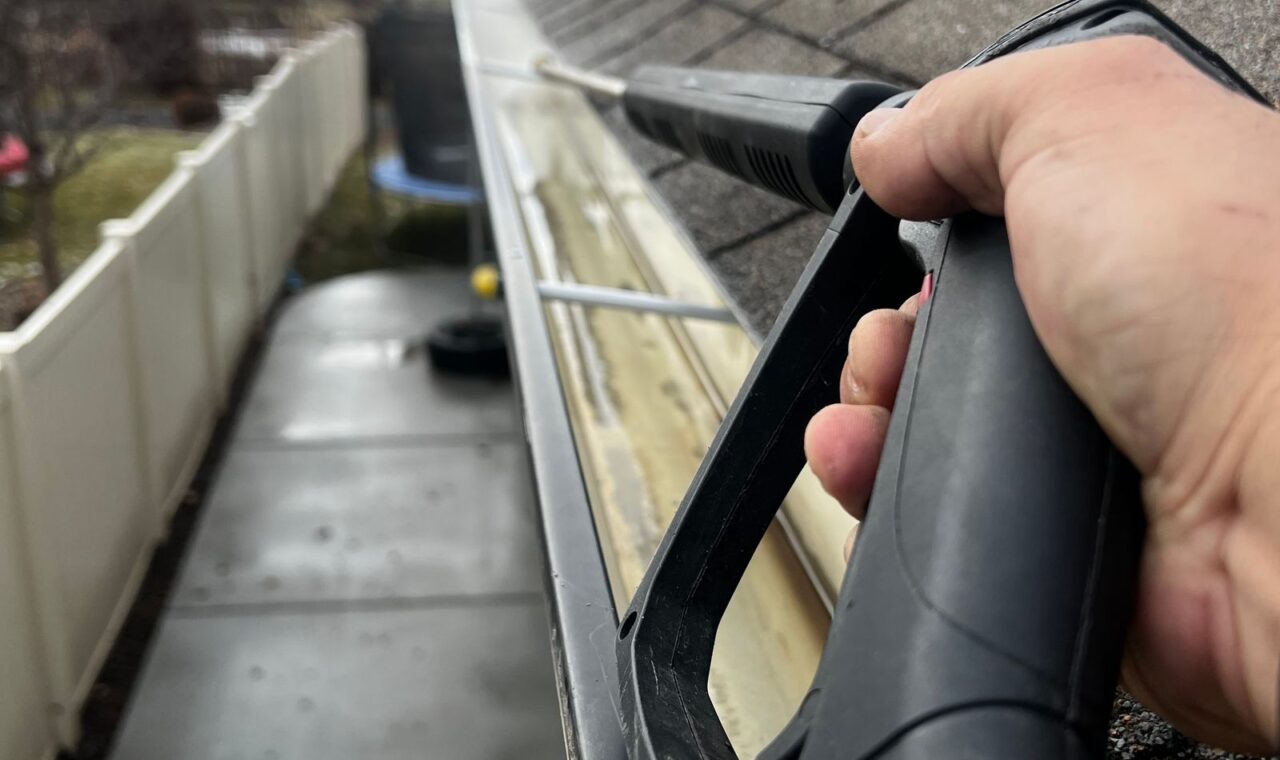 Residential gutter cleaning in progress